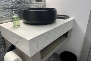 custom quartz bathroom countertop with stone vessel sink